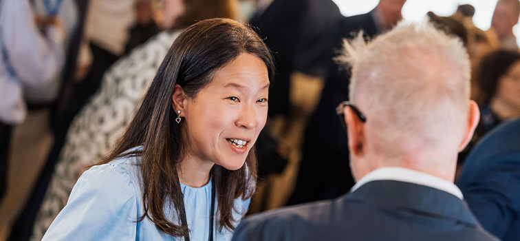 756x350-Image-5 Attendee of the Sandbox Programme Event at Central Bank of Ireland smiling and talking to a man