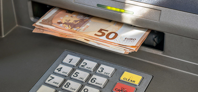 ATM machine displaying a number of €50 notes Decorative image. ATM machine displaying a number of €50 notes