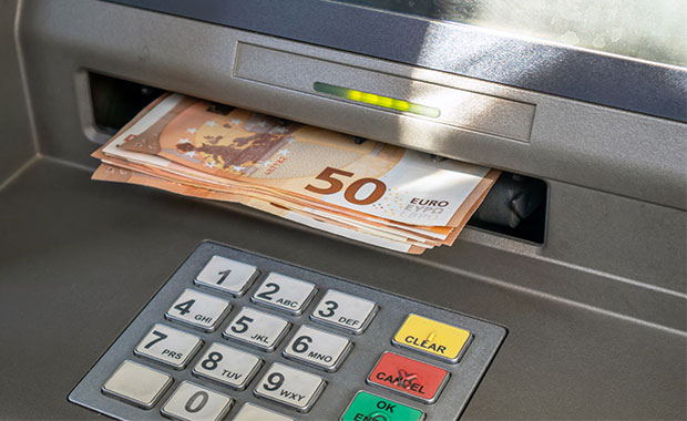 Bunch of 50euro notes being dispensed from an ATM