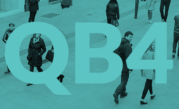 People walking on a street with a green monochrome shade with QB4 written on image