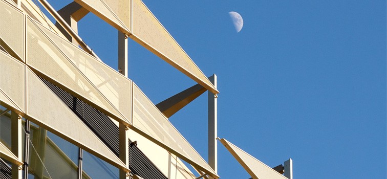 Gold metal facade building with a blue sky