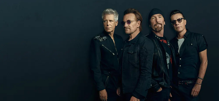 U2 band members with a black background