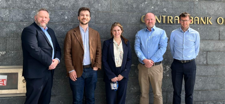 Five people standing in front of Central Bank of Ireland North Wall Quay building