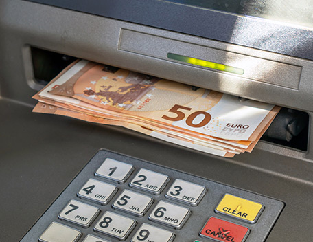 ATM machine dispensing a  number of €50 notes