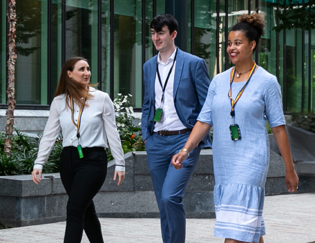 Three people walking outside
