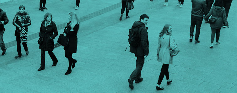 Groups of people walking on a street with a green background