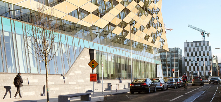 Outside of Central Bank building with cars parked on street